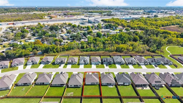 an aerial view of a swimming pool patio and outdoor seating