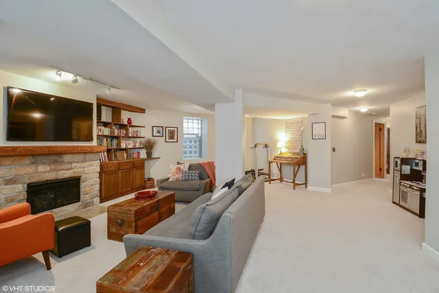 a living room with furniture a fireplace and a flat screen tv