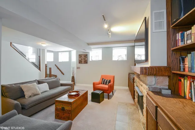 a living room with furniture and a book shelf