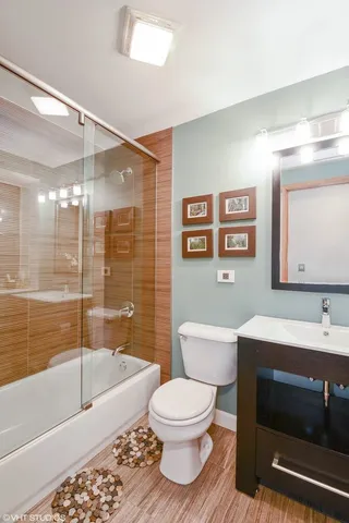 a bathroom with a sink toilet a mirror and bathtub