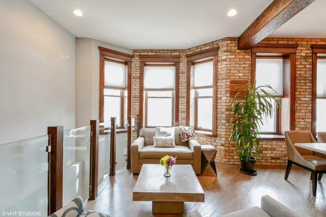 a living room with furniture and floor to ceiling windows