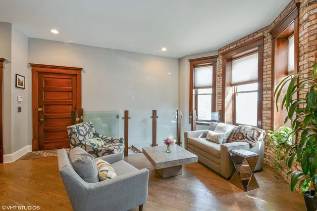a living room with furniture and floor to ceiling windows