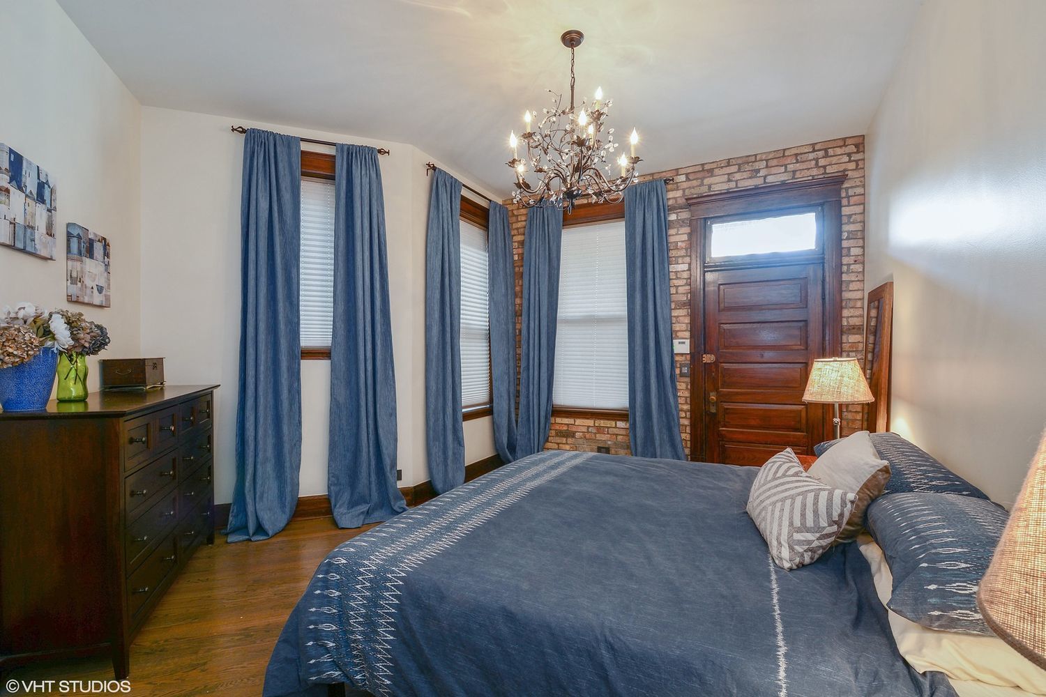 2608 North Dayton Street, Unit 1S Chicago, IL 60614 - Photo 9 of 17 a bedroom with a bed chandelier and a window