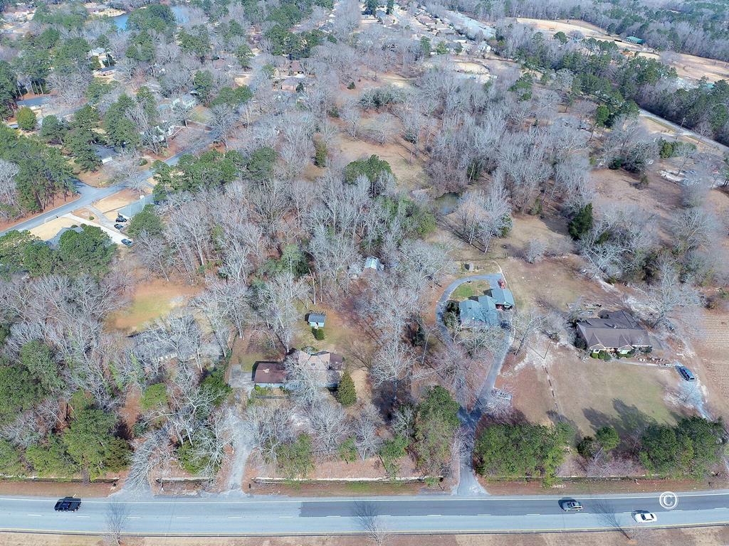 a view of a dry field with trees