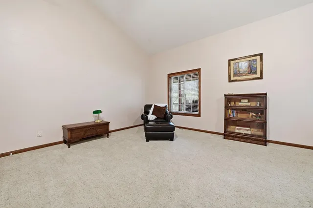 a living room with furniture a dining table and a chandelier