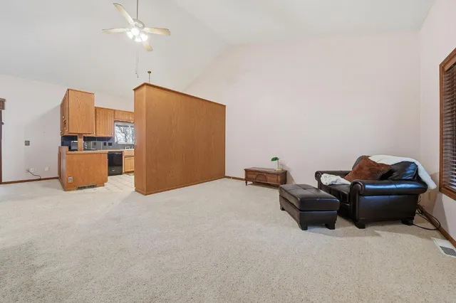 a kitchen with kitchen island granite countertop a sink counter top space appliances and cabinets