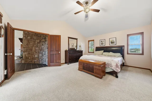 an aerial view of residential houses with outdoor space and trees