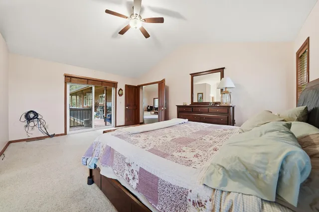 a aerial view of a house with a yard and lake view