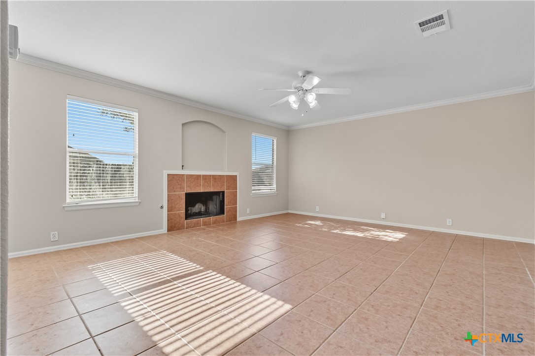 172 Coreopsis Cove Kyle, TX 78640 - Photo 17 of 33 a view of empty room with a fireplace and fan