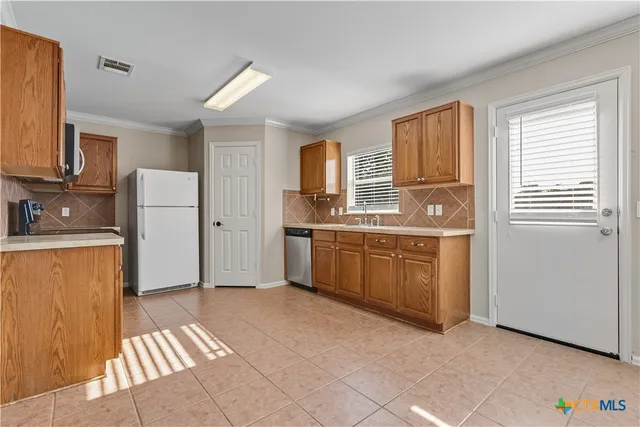 a kitchen with a sink a stove and cabinets