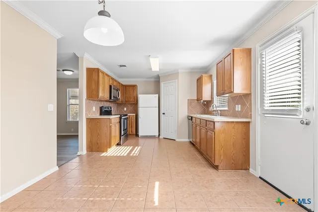 a kitchen with refrigerator cabinets and a sink