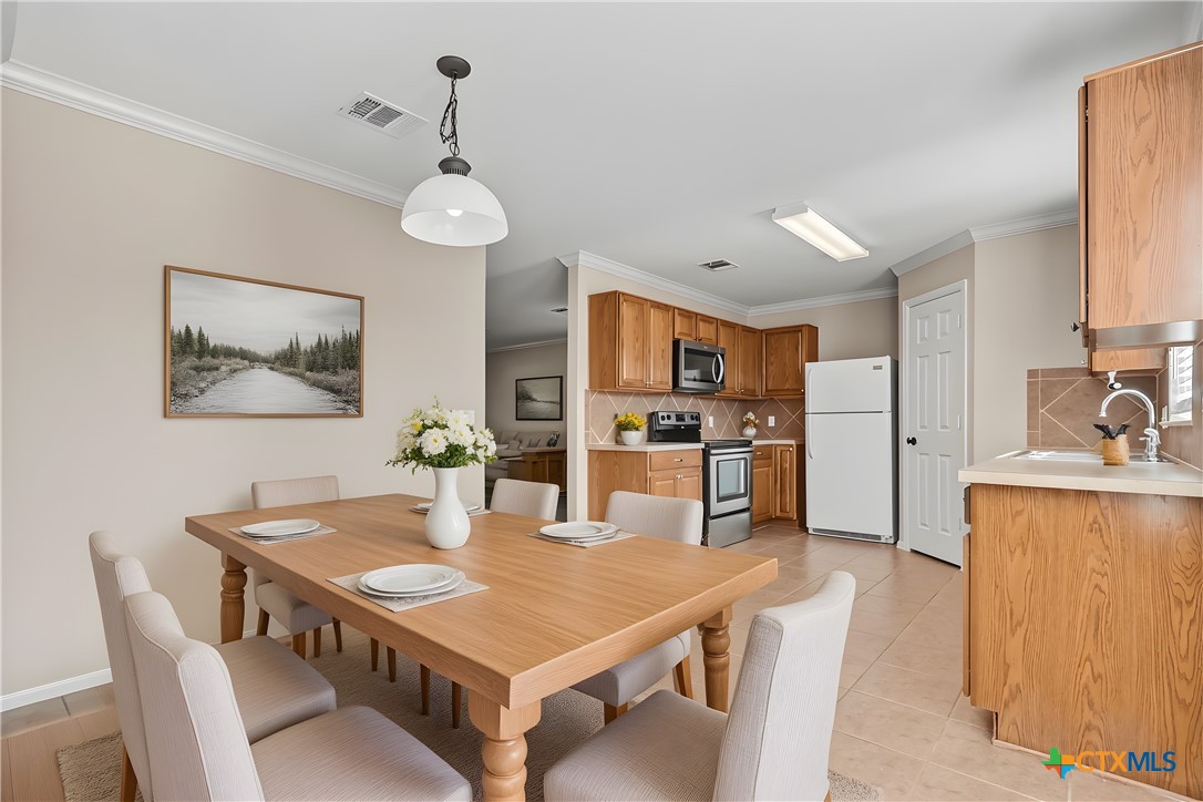 172 Coreopsis Cove Kyle, TX 78640 - Photo 20 of 33 a view of a dining room with furniture and wooden floor