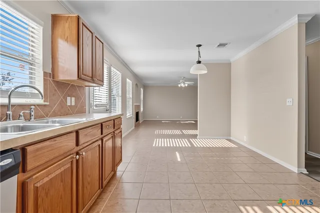 a view of a kitchen with an entryway and a sink