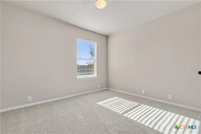 a view of room with window and hardwood floor