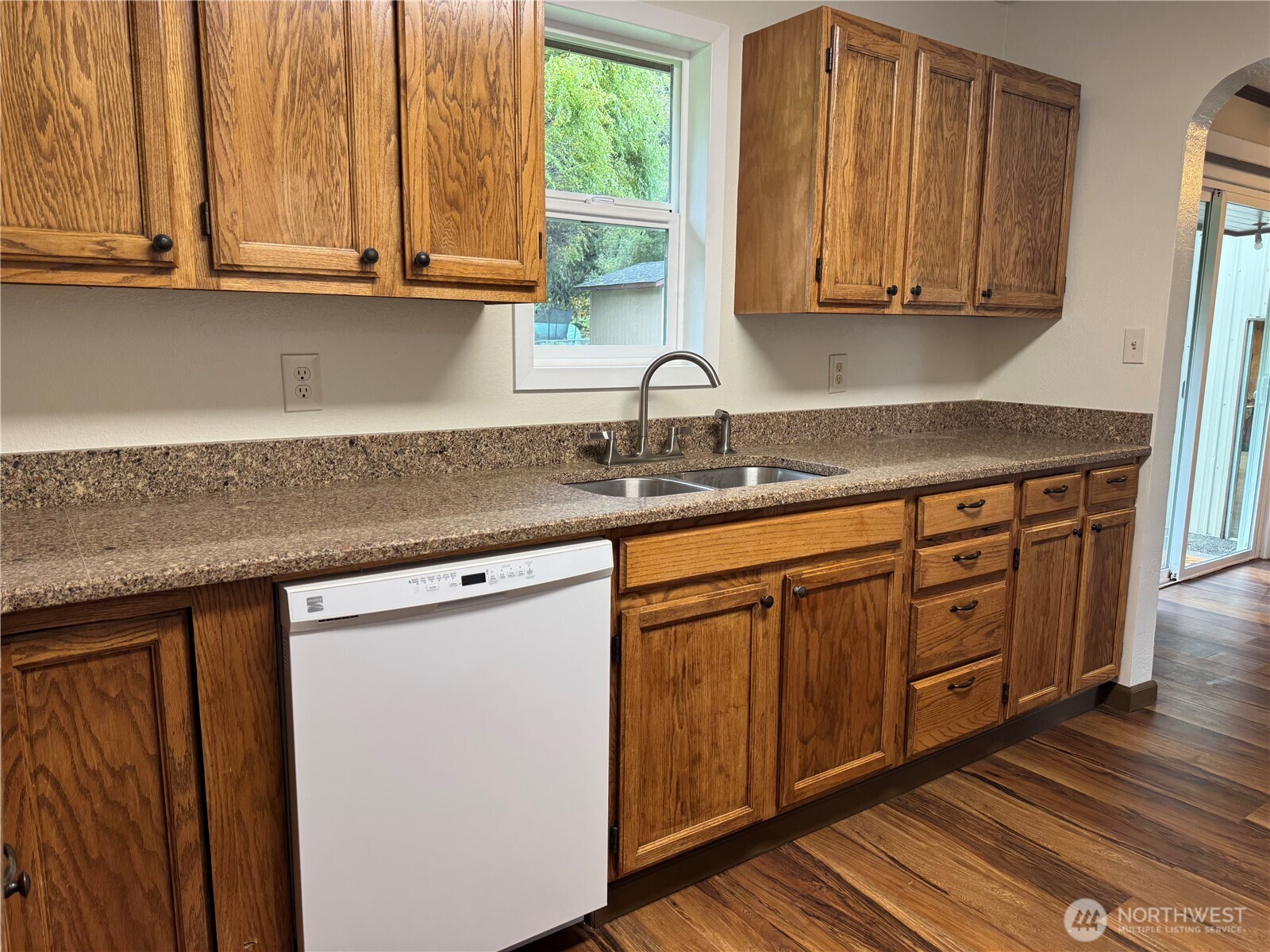 212 McGeary Road Kelso, WA 98626 - Photo 4 of 20 a kitchen with stainless steel appliances granite countertop wooden cabinets a sink and dishwasher with wooden floor