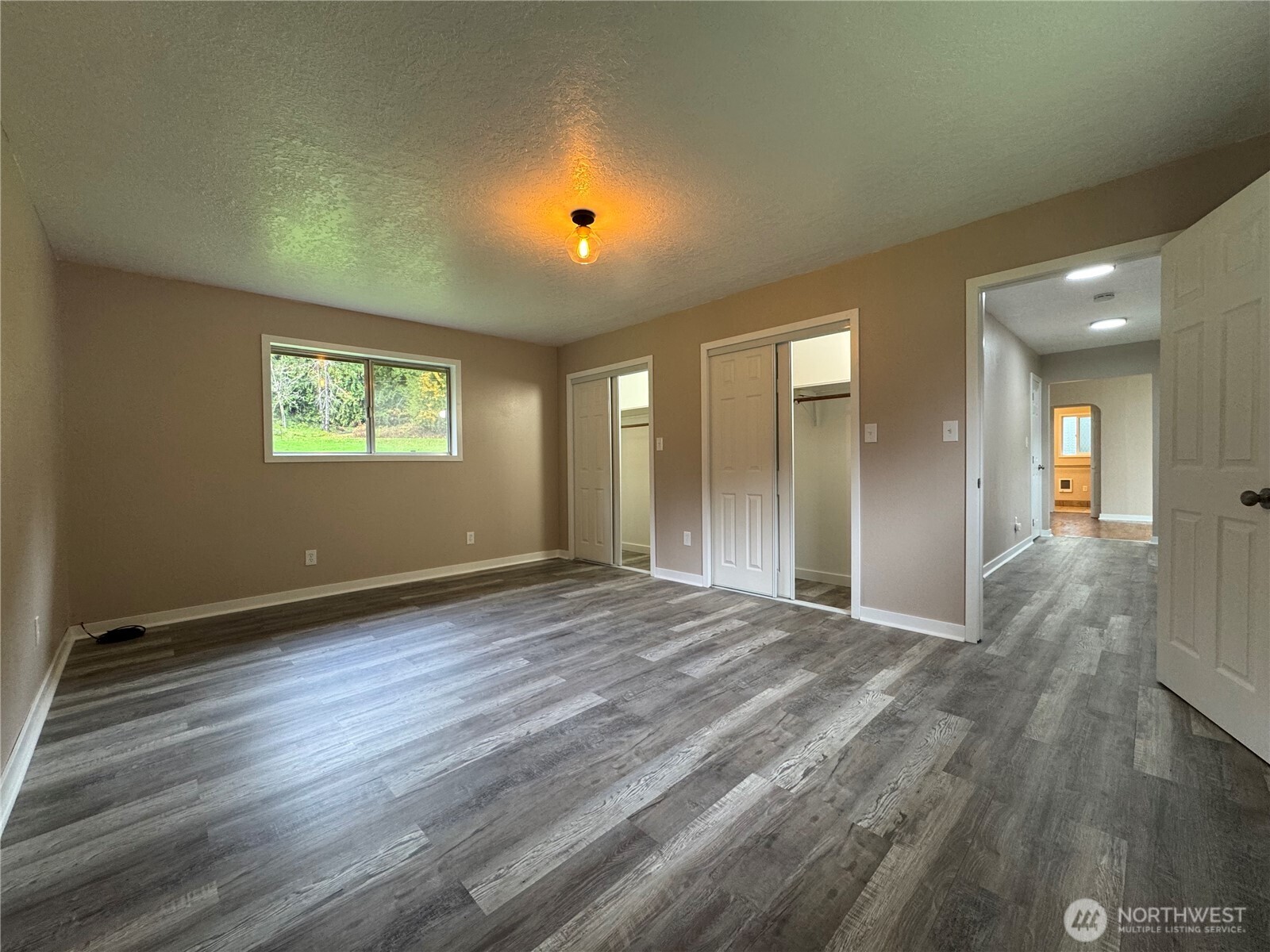 212 McGeary Road Kelso, WA 98626 - Photo 7 of 20 an empty room with wooden floor and windows