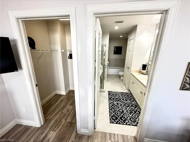 a view of a hallway view with wooden floor and staircase