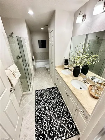 a bathroom with a double vanity sink and mirror