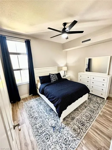 a bedroom with a large bed and a window