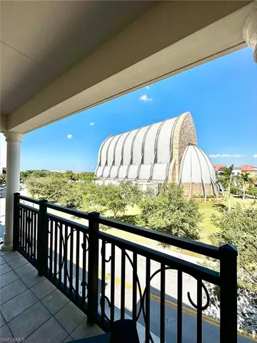 a view of a balcony with wooden fence