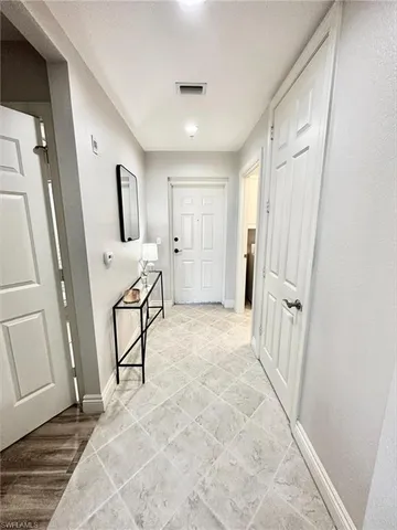 a view of a hallway with furniture and front door