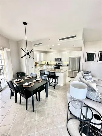 a living room with furniture a rug and a window