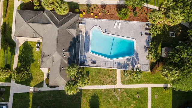 an aerial view of a house having a yard