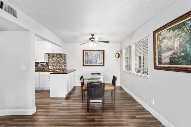 a living room with furniture and a painting on the wall