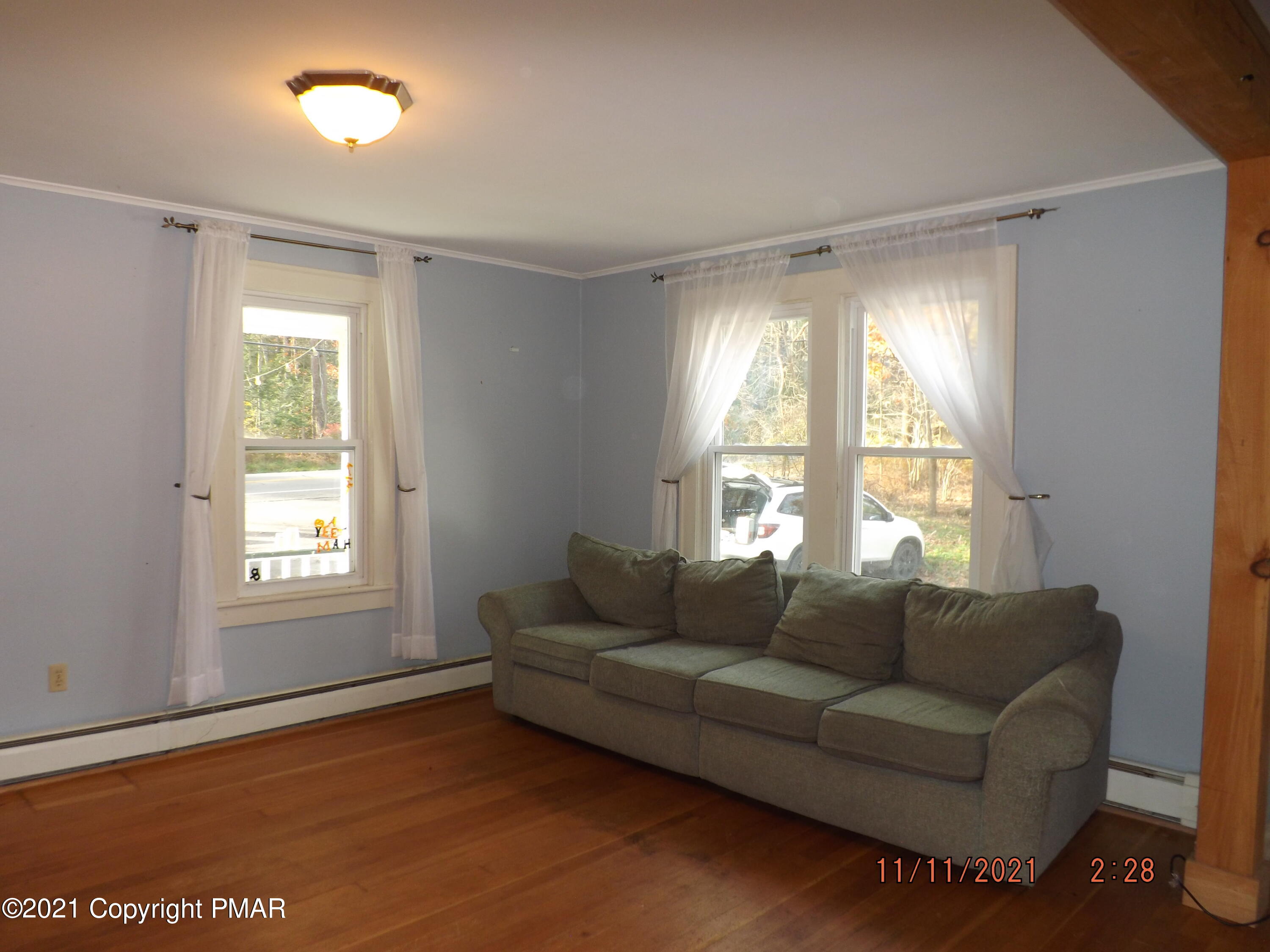 5474 Paradise Valley Road Cresco, PA 18326 - Photo 12 of 34 a living room with furniture and a large window