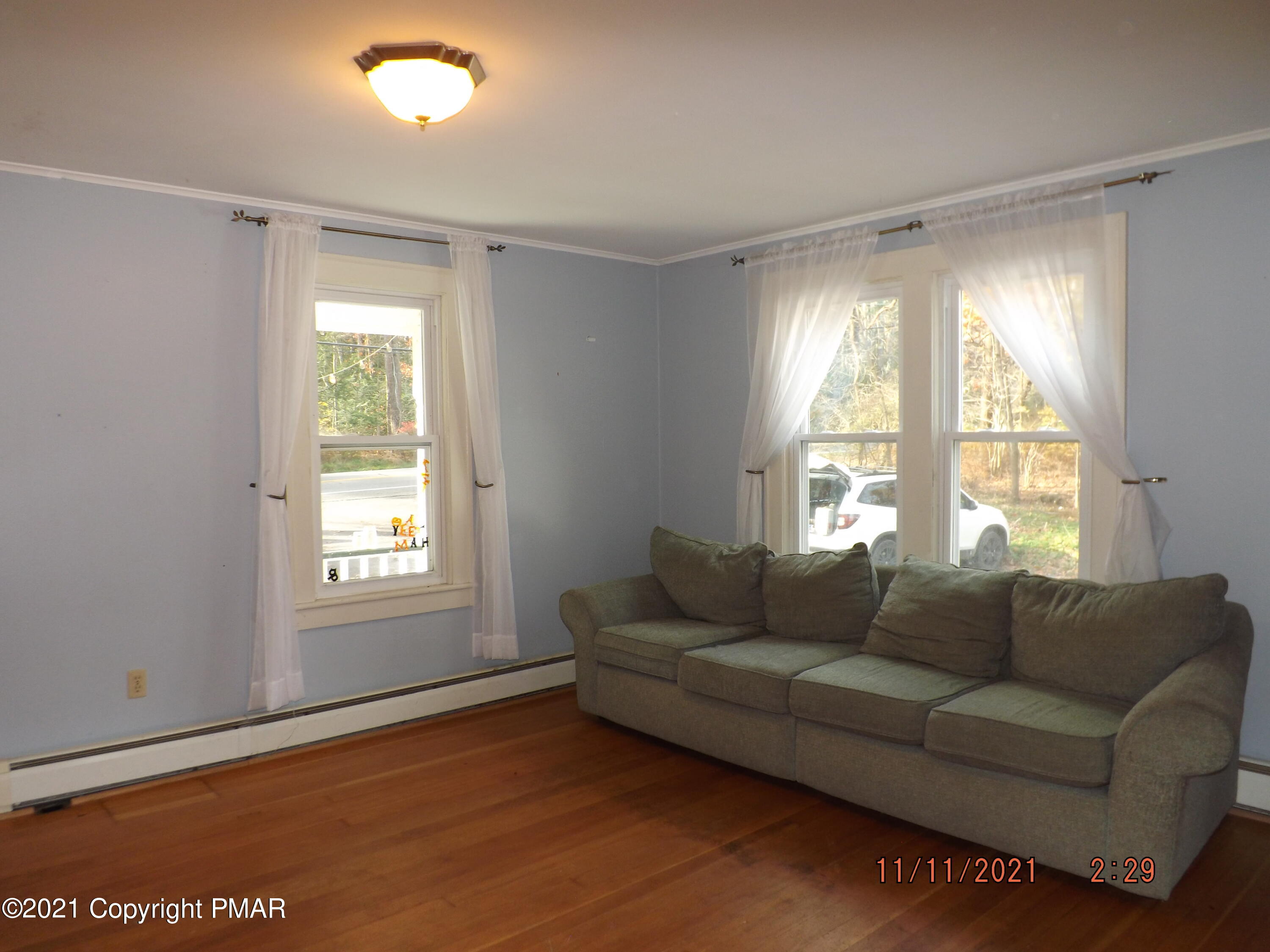 5474 Paradise Valley Road Cresco, PA 18326 - Photo 13 of 34 a living room with furniture and a window