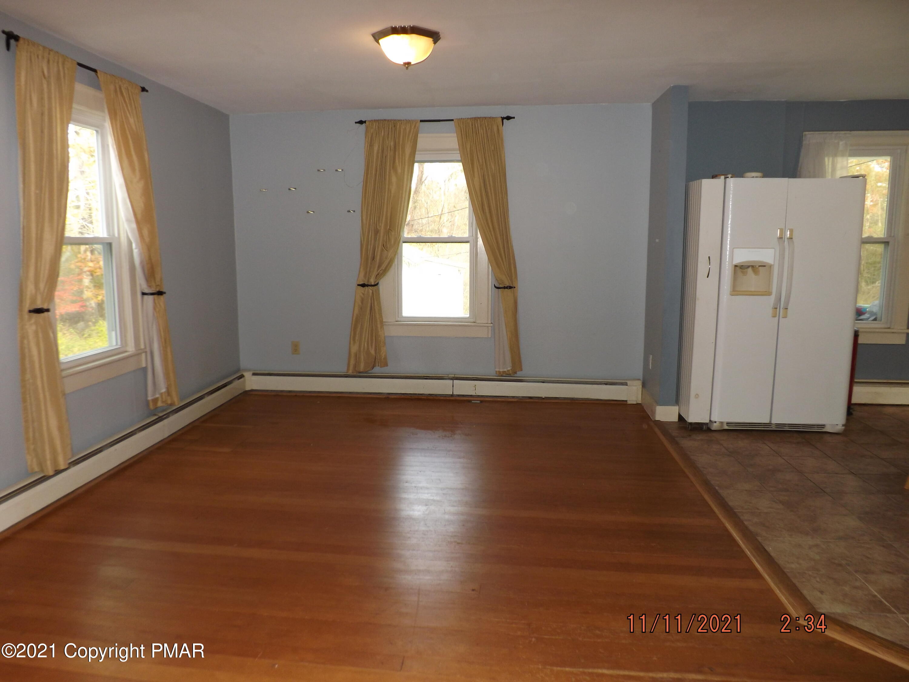 5474 Paradise Valley Road Cresco, PA 18326 - Photo 15 of 34 an empty room with wooden floor and windows