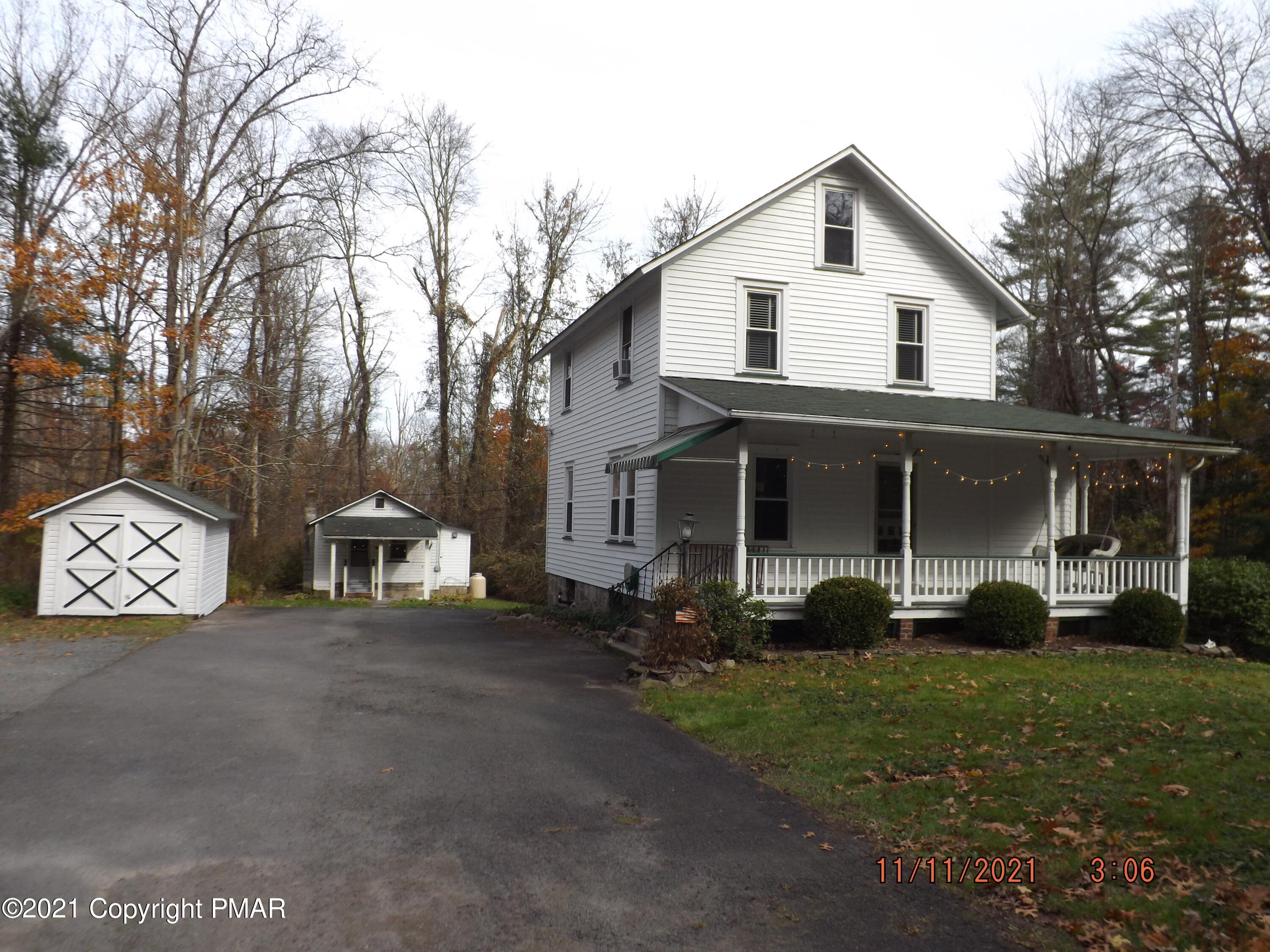 5474 Paradise Valley Road Cresco, PA 18326 - Photo 2 of 34 a front view of a house with garden
