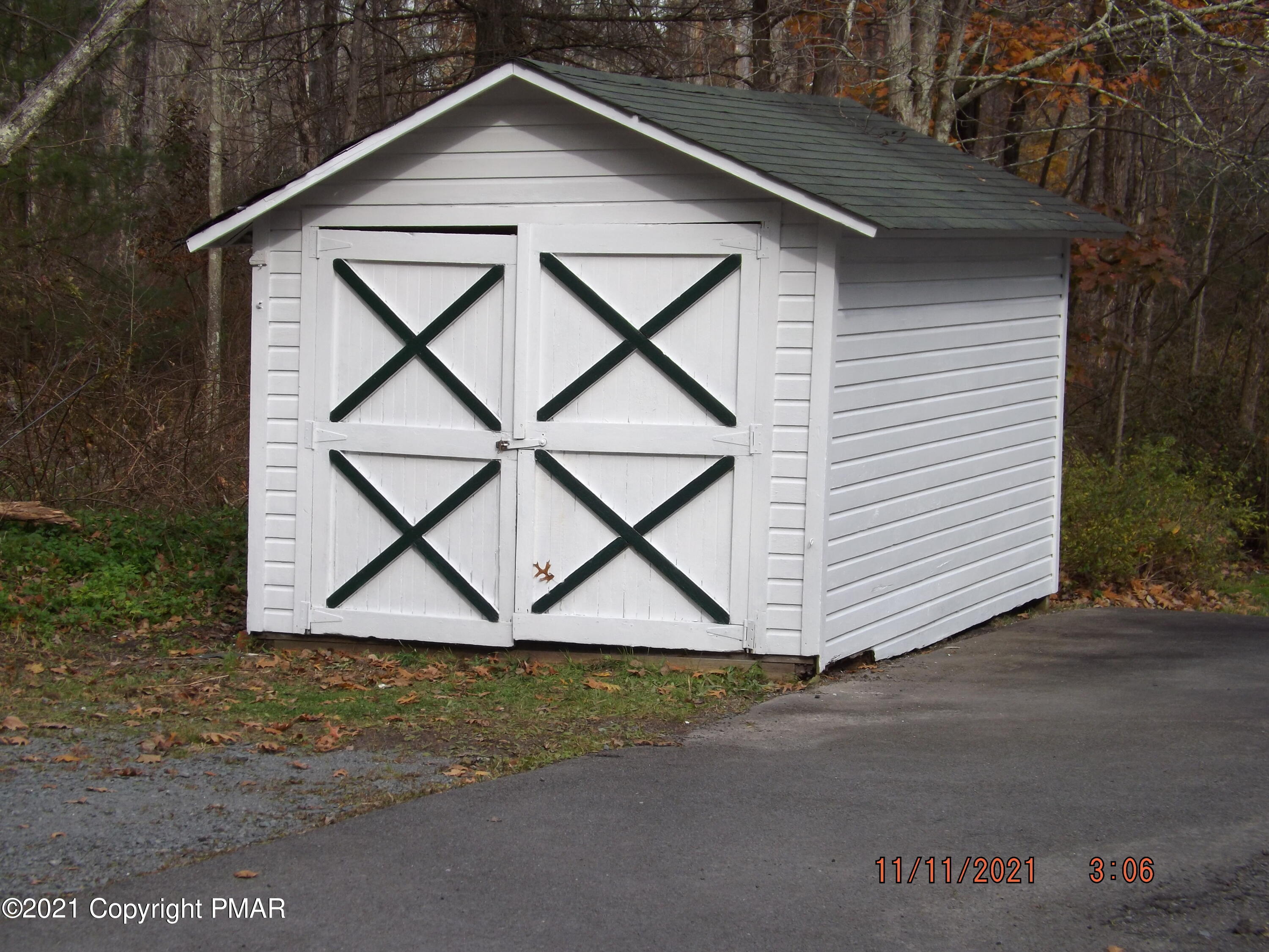 5474 Paradise Valley Road Cresco, PA 18326 - Photo 32 of 34 a view of barn with a small yard and plants