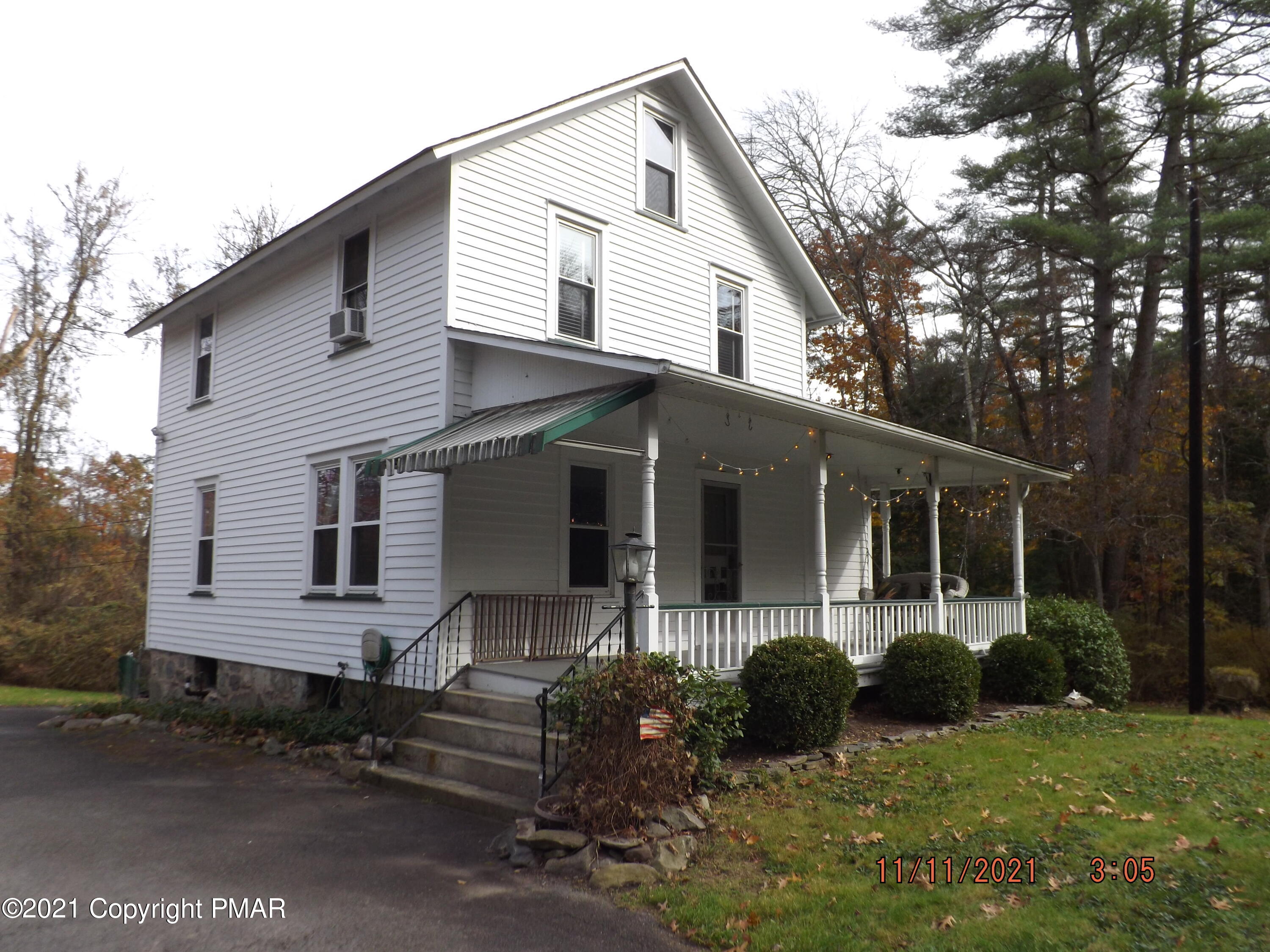 5474 Paradise Valley Road Cresco, PA 18326 - Photo 4 of 34 a front view of a house with garden