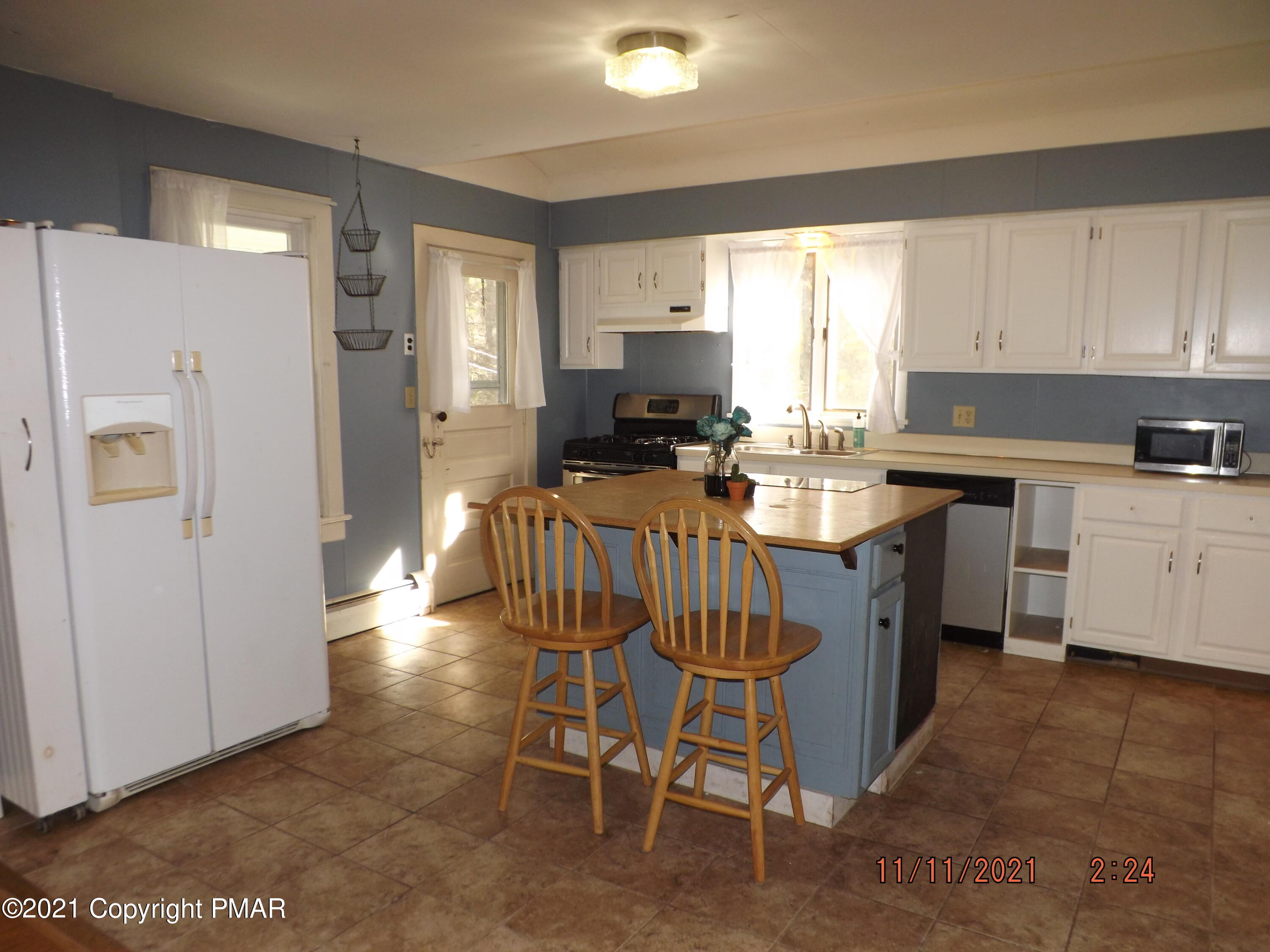 5474 Paradise Valley Road Cresco, PA 18326 - Photo 5 of 34 a kitchen with stainless steel appliances a stove a sink refrigerator and a cabinets