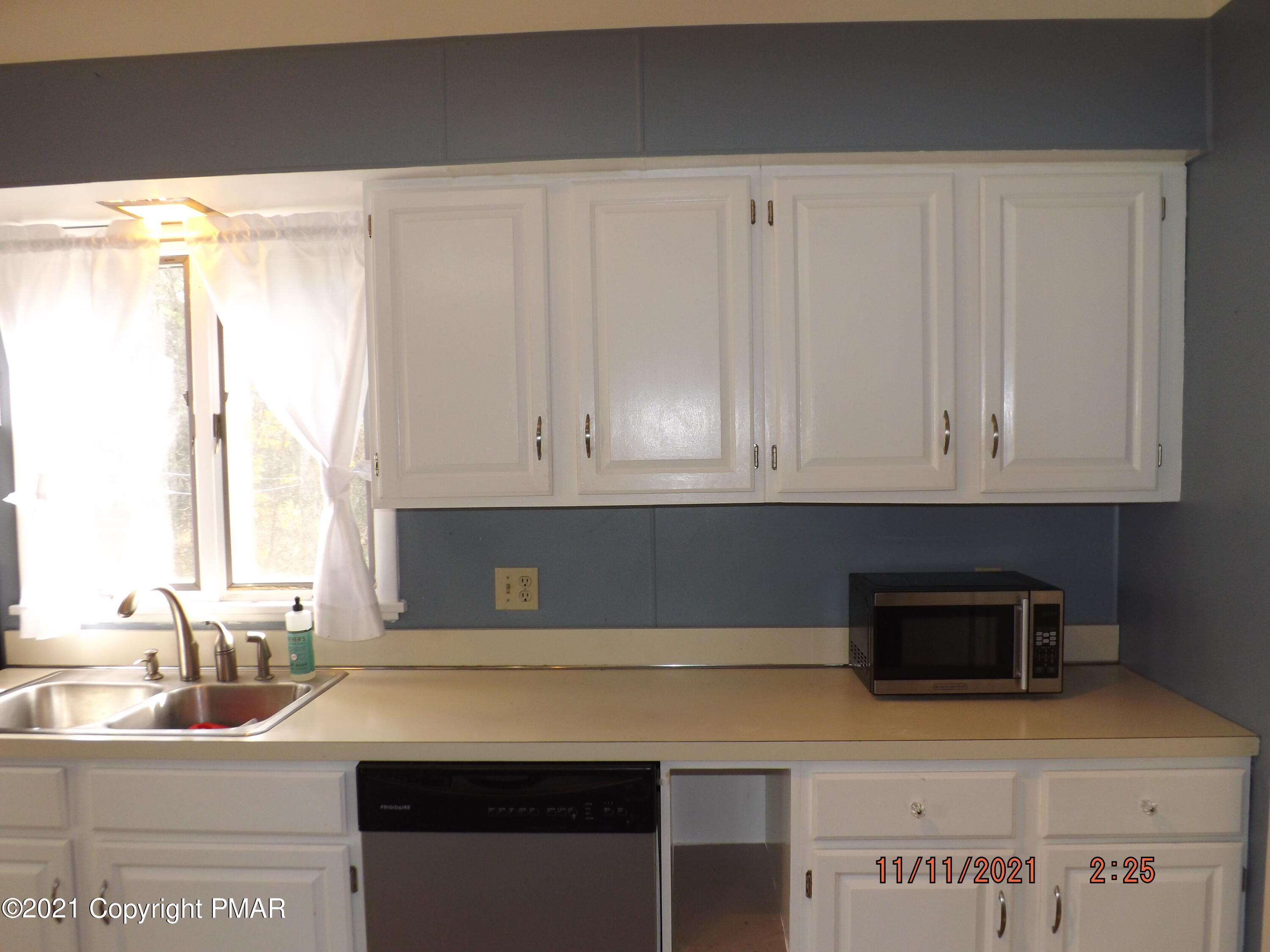5474 Paradise Valley Road Cresco, PA 18326 - Photo 7 of 34 a kitchen with stainless steel appliances white cabinets and a sink