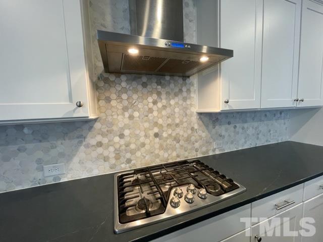 1425 Barn Door Drive Apex, NC 27502 - Photo 12 of 43 a stove top oven sitting inside of a kitchen