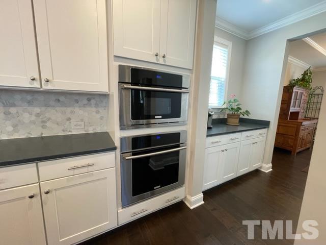 1425 Barn Door Drive Apex, NC 27502 - Photo 13 of 43 a kitchen with granite countertop white cabinets and stainless steel appliances