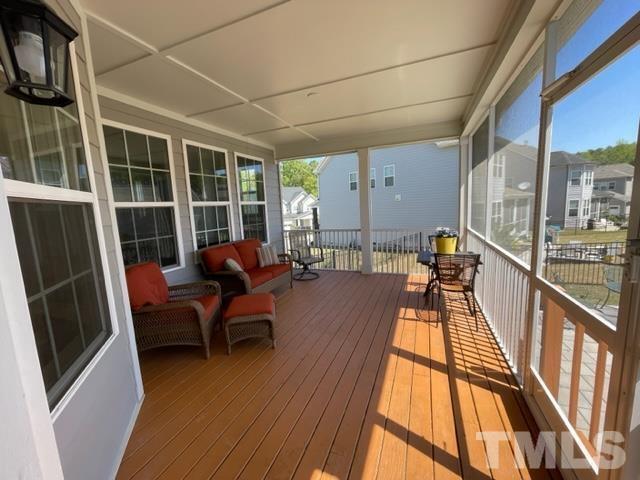 1425 Barn Door Drive Apex, NC 27502 - Photo 22 of 43 a sitting area with furniture and wooden floor