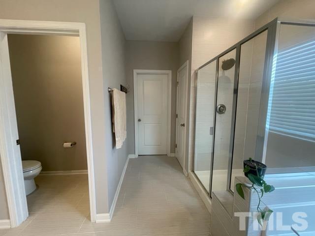 1425 Barn Door Drive Apex, NC 27502 - Photo 34 of 43 a view of a bathroom with a shower and a toilet