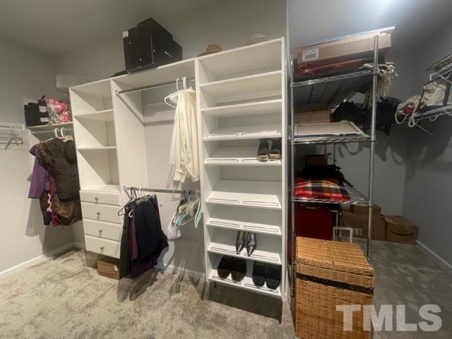 1425 Barn Door Drive Apex, NC 27502 - Photo 35 of 43 a view of walk in closet with clothes and shoes