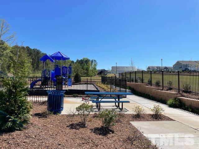 1425 Barn Door Drive Apex, NC 27502 - Photo 43 of 43 a view of a swimming pool with couches and wooden floor