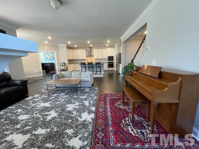 1425 Barn Door Drive Apex, NC 27502 - Photo 8 of 43 a living room with furniture and wooden floor