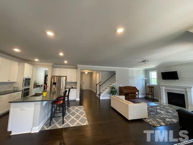 1425 Barn Door Drive Apex, NC 27502 - Photo 9 of 43 a living room with fireplace furniture and a flat screen tv