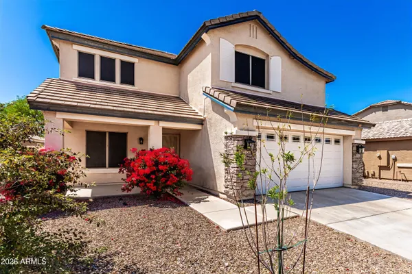 a front view of house with a garden
