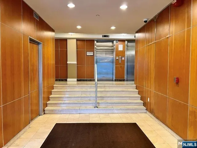 a lobby with furniture and a chandelier
