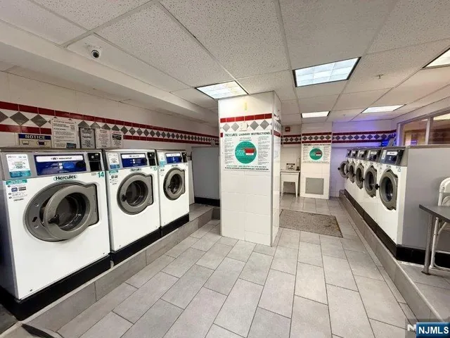 a view of a kitchen with stainless steel appliances granite countertop a stove and a sink