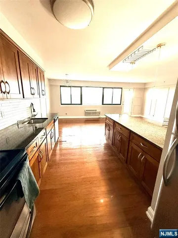 a view of a room with wooden floor