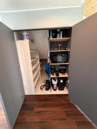 a bedroom with a bed and a large mirror