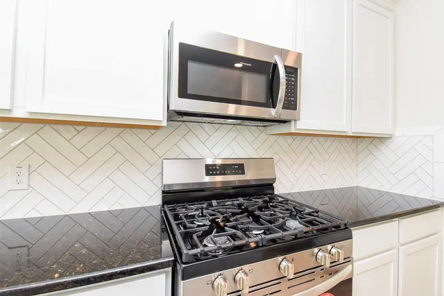 a kitchen with a stove and a microwave